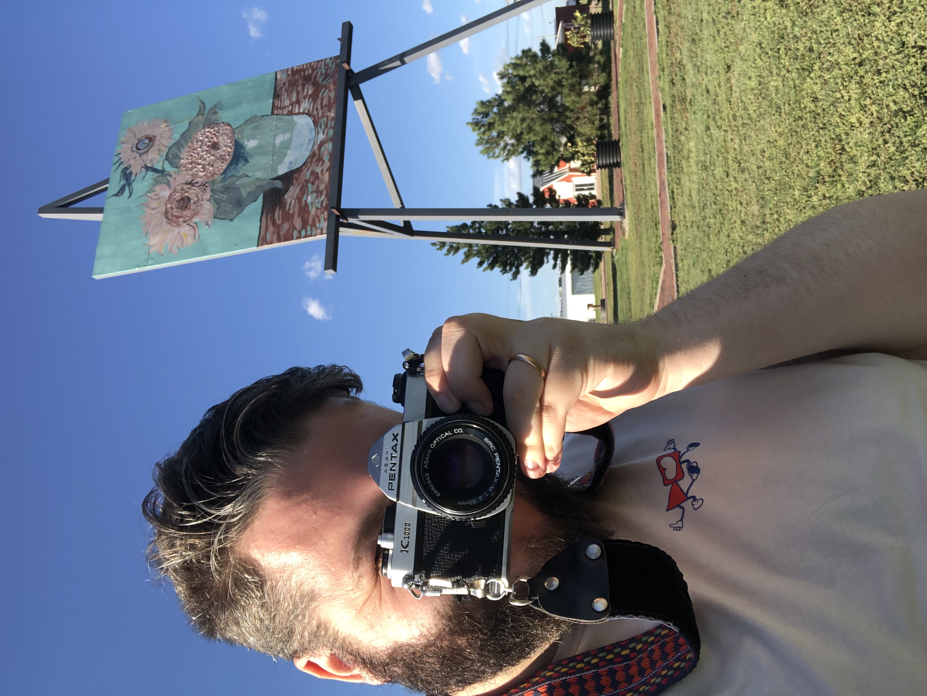 Selfie with my Pentax k-1000 in front of the World's Largest Van Gogh Painting in Goodland, Kansas.