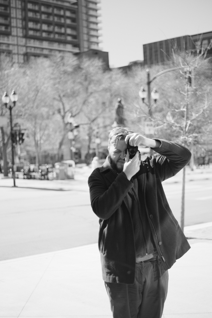 Self portrait taken in the reflection of a building in downtown Hamilton, Ontario.