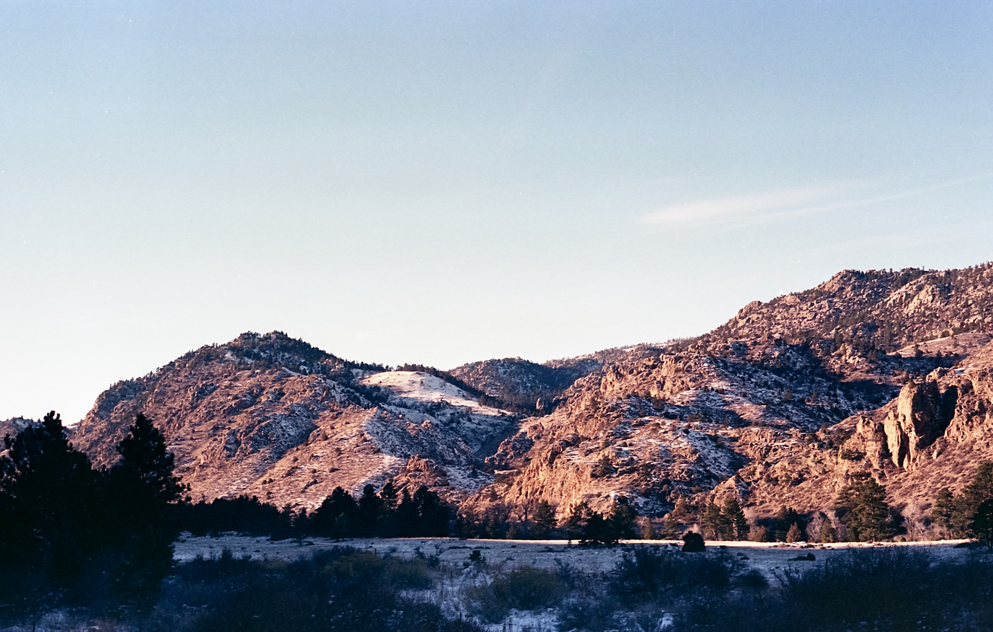 Mountains coated in an early December blanket of snow, and bathed in the golden glow of sunset.